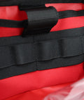 Close-up of red Lightning X first aid kit accessory pouch with black MOLLE straps