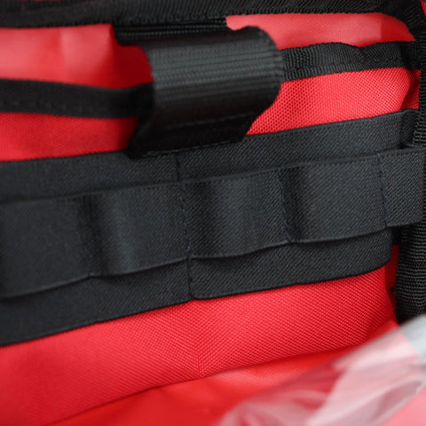 Close-up of red Lightning X first aid kit accessory pouch with black MOLLE straps