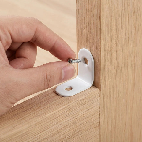 Hand installing a screw into a white finish stainless steel right angle corner bracket for wood shelves with wear resistant hardware