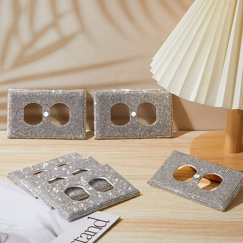 10 Pack Silver Rhinestone Wall Plate Outlet Covers Bling Decor For Home Rooms with screws on a wooden table next to a lamp