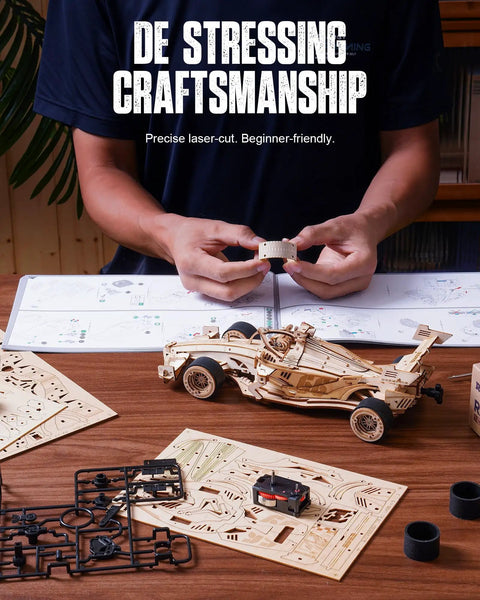 Hands assembling 1 To 18 Scale Formula Racing Car Puzzle Kit For Adults, Wind Up Wooden Model Car Kit, parts on table.