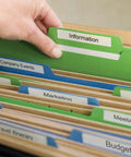 Hand reaching for green labeled file marked 'Information' among colorful folders for organized filing.