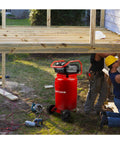 20 Gallon Oil Free Air Compressor With 1.8 HP Motor Pushing A Full 175 PSI dual quick couplers in vibrant red at a construction site.