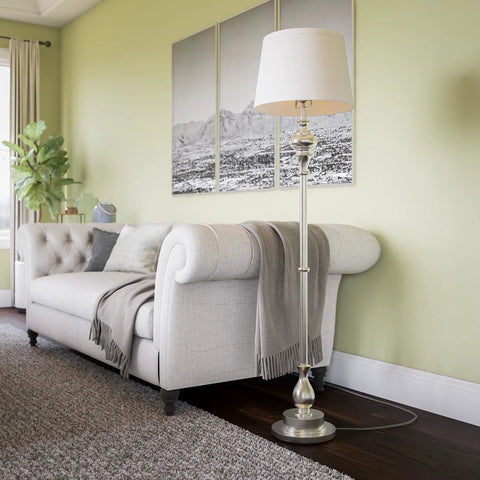 Tall Brushed Steel Floor Lamp With Classic Style, 59 Inch Height next to sofa in living room, 15 Inch Drum Shade, 3-Way Bulb Or LED Compatible.