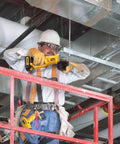 Kickass 20V Max Cordless Angle Grinder Kit With Four Inch Disc And 8000 Rpm Brushless Motor in use by a worker on scaffolding.