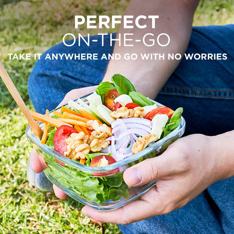 Person holding a salad in a 35 Piece Glass Food Storage Set With Airtight Lids For Easy Meal Prep BPA Free Leak Proof Bento Boxes.