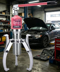 Heavy Duty Hydraulic Gear Puller And Bearing Separator With Adjustable Three Jaw Hub Remover For Flanges Motors Gears Auto Repair Shop Work 30 Ton 66000 LB Capacity Built Like A Tank For Grease Monkeys in a workshop setting with tools.