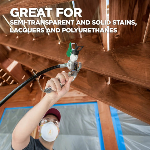 Person using High Efficiency Airless 413 Reversible Spray Tip For Sealers And Stains on wooden fence, ControlMax sprayer visible