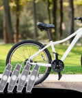 4 Pack Bike Wheel Reflectors For Night Riding Bicycle Spoke Reflectors For Mountain And Road Bikes with a white bicycle in background.