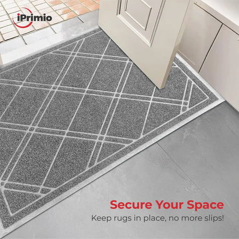 Entrance rug with NeverCurl Double Sided Rug Tape With Mesh Fabric, showing no curl corners on gray patterned mat over tile floor.