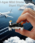Hand holding All Ages Mini Drone For Easy Stunt Flights With 360 Degree Tricks in front of plane and clouds
