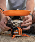 Summit Skillet Nonstick Camping Cookware on backpacking stove, ceramic-coated pan with orange handle, outdoors, easy setup