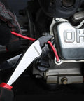 Heavy Duty Wire Cutter Crimper Tool For 10 To 22 AWG Terminals And Connectors shown cutting red wire next to engine
