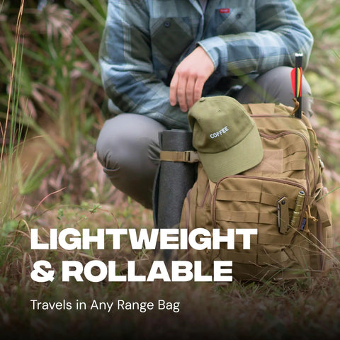Person carrying a khaki backpack with attached rolled-up mat and cap in outdoor setting, highlighting portability and utility.