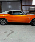 Showroom Smooth Dreamsicle Orange Basecoat Paint Gallon Ready To Spray Mix With Slow Reducer For Zero Hassle Street Car Restorations And Bumper To Bumper Shine on a classic car in a garage.
