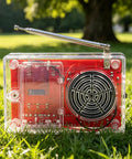 Hands On DIY FM Radio Soldering Kit For Electronics Learning Solder Practice Essentials Build A Functional FM Radio Speaker Beginner Friendly Kit With English Instructions And Easy Assembly showcasing clear casing and antenna on grass