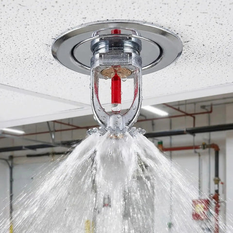 10 Pack Solid Copper Fire Sprinkler Heads 155F Upright Spray Half Inch NPT Thread releasing water from the ceiling.