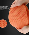 Close-up of orange buffing pad from Five Piece Seven Point Five Inch Buffing Polishing Pad Kit showing texture and hands holding pad