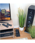 Living room setup with Home Theater Surge Protector Power Strip with 12 Outlets 2160 Joules behind sound system.