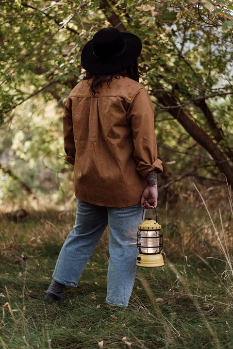 Person holding Dusty Yellow Forest Lantern Vintage Rechargeable Led Lantern With Adjustable Brightness Battery Operated Camping Light outdoors