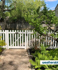 Heavy Duty Double Gate Hardware Kit For Outdoor Vinyl Fences Featuring Knockout Locking Latch view, showcasing white vinyl gate in garden setting.