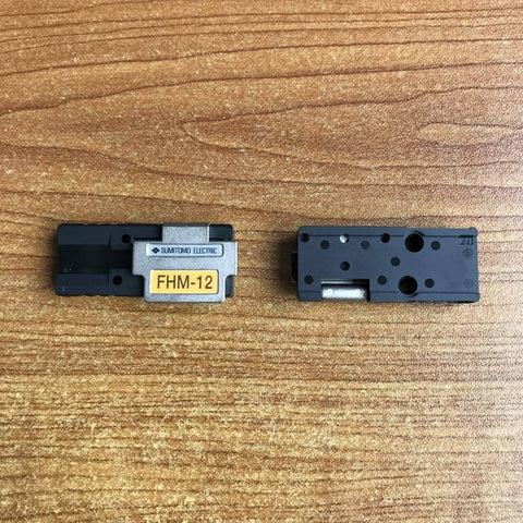 FHM-12 Fiber Holder Sheath Clamp Chucking Fixture Jigs For Ribbon Splicer Type-66M12 on wooden surface, shown front view