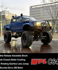 Beefed Up 1/16 Scale RC Rock Crawler With 4x4 Drive All Terrain Off Road Pickup RTR Hobby Grade Vehicle showing front view on wet pavement.