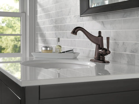 Mylan Single Hole Bathroom Faucet Venetian Bronze with Drain Assembly installed on marble countertop near window