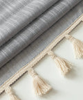 Close-up of Linen Textured Swag Curtain Valance With Rod Pocket showing gray fabric and tassel details, 36W X 36L, soft linen polyester blend.