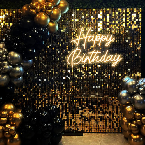 Happy Birthday Neon Sign For Backdrop Small 16.5 X 12.2 Inches LED Light Up Birthday Sign With Dimmable Switch Warm White Glow Photo Backdrop Decor For Parties Easy Setup glowing on a gold and black backdrop with balloon decorations.