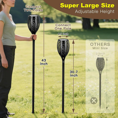 Person holding 4 Pack 96 LED Solar Tiki Torches With Flickering Flame 43 Inch Tall Outdoor Lights Waterproof for garden or yard