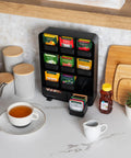 Tea Bag Organizer Station For Countertop And Kitchen Storage, Black Plastic, 10.25L X 3.25W X 13.75H Inches on marble counter
