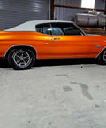 Showroom Smooth Dreamsicle Orange Basecoat Paint Gallon Ready To Spray Mix With Slow Reducer For Zero Hassle Street Car Restorations And Bumper To Bumper Shine on vintage car side view.