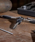 Close-up of ergonomic T handle from 27 Piece Metric Ratcheting Tap And Die Set With 72-Tooth Fine Ratchet, 5 Degree Swing, visible on a workbench
