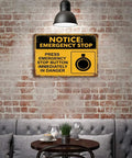 Emergency Stop Button Safety Sign Vintage Tin Wall Decor 8x12 Inch Yellow And Black Industrial Plaque on brick wall in cozy setting.