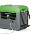 Industrial Grade 150 Pint Commercial Dehumidifier With Built In Pump And Drain Hose, green and gray unit with drainage hose.