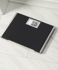 Heavy Duty Body Weight Scale With Extra Wide 15 Inch By 13 Inch Platform on tile floor, black surface, backlit LCD display