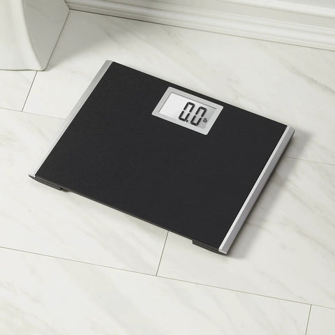Heavy Duty Body Weight Scale With Extra Wide 15 Inch By 13 Inch Platform on tile floor, black surface, backlit LCD display