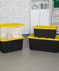 Tough As Nails 27 Gallon Plastic Storage Totes With Secure Locking Lids For Garage Organization 16 Pack stacked in a garage.