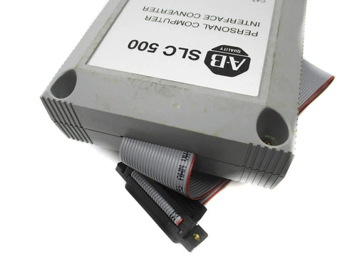 1747 Pic Series A Plc Converter Module Offering Killer Performance For Your Industrial Automation And Programming Needs Available In New Surplus Factory Sealed Or Remanufactured Like New Condition. gray PLC converter module with ribbon cable and connector