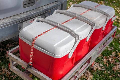 All Weather Must Have Adjustable Flat Bungee Cord From 10 In To 54 In securing red coolers on a trailer outdoors