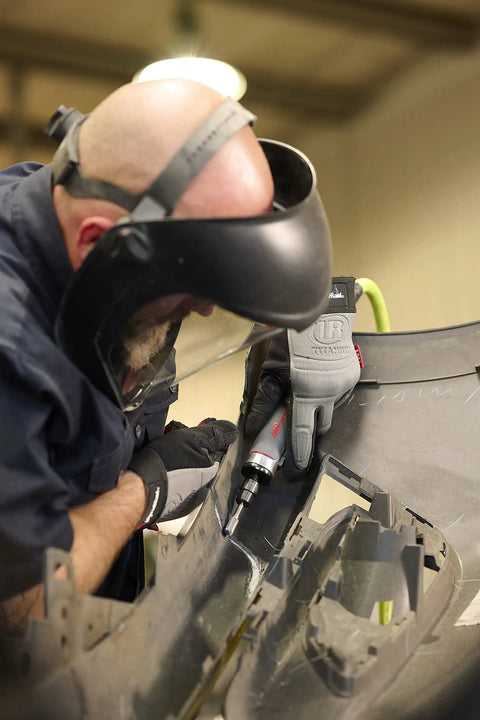 Technician using Beast Power Air Die Grinder With 25,000 RPM and 0.4 HP on auto part in workshop setting.