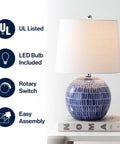 Navy Ceramic Hand Painted Scallop Sphere Table Lamp With White Linen Drum Shade For Coastal Transitional Bedside And Living Room Vibe LED Bulb Included ETL Listed 120 Volt Safe And Stylish on a table