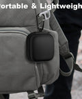 Carry Anywhere EVA Earbud Case With Carabiner attached to a gray backpack, showing portable design, black, compact size.