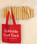 Foldable Wall Coat Rack With Five Hidden Hooks, holding a red bag, modern wooden wall mount design, slim profile for narrow hallways.