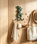 Premium Cast Iron Mermaid Wall Hook With Solid Metal Finish Totally Awesome Vintage Nautical Coat And Towel Hanger holding towels.