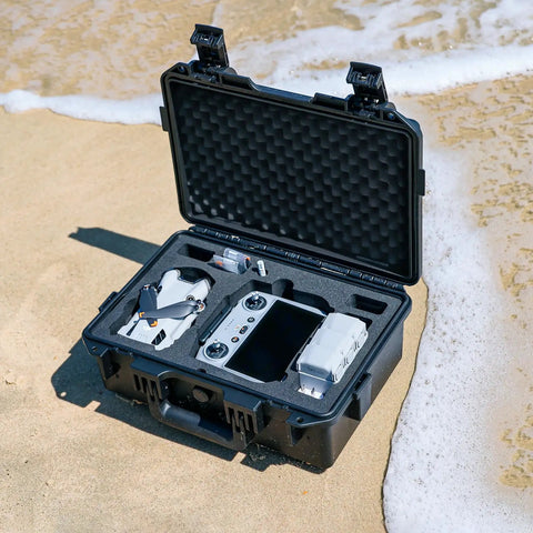 Open waterproof hard case for DJI Mini 4 Pro Mini 3 Pro and RC transmitters RC 2 RC N2 N1 with foam padding on sandy beach