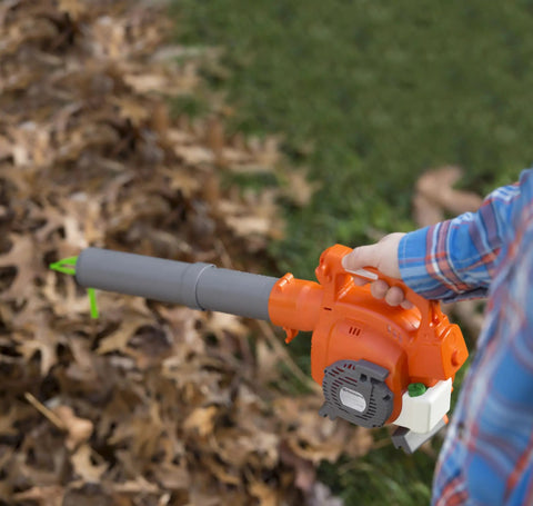 Child using Real Feel Toy Leaf Blower That Lights Up And Actually Blows Air Kid Friendly Mini Tool For Ages 3 And Up in orange and gray