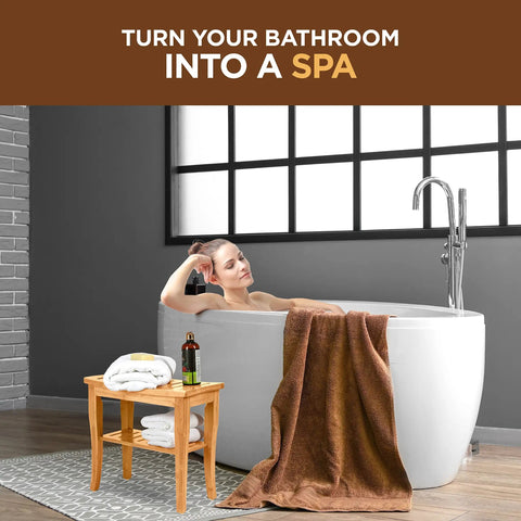 Woman relaxing in bath with Dope Bamboo Shower Bench Spa Stool With 2 Tier Wood Seat And Storage Shelf, non-slip feet nearby.