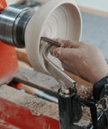 BMWOOD 1in stem-glide bowl-turning toolrest in-use on wood lathe; front view of gloved hand shaping a white bowl.